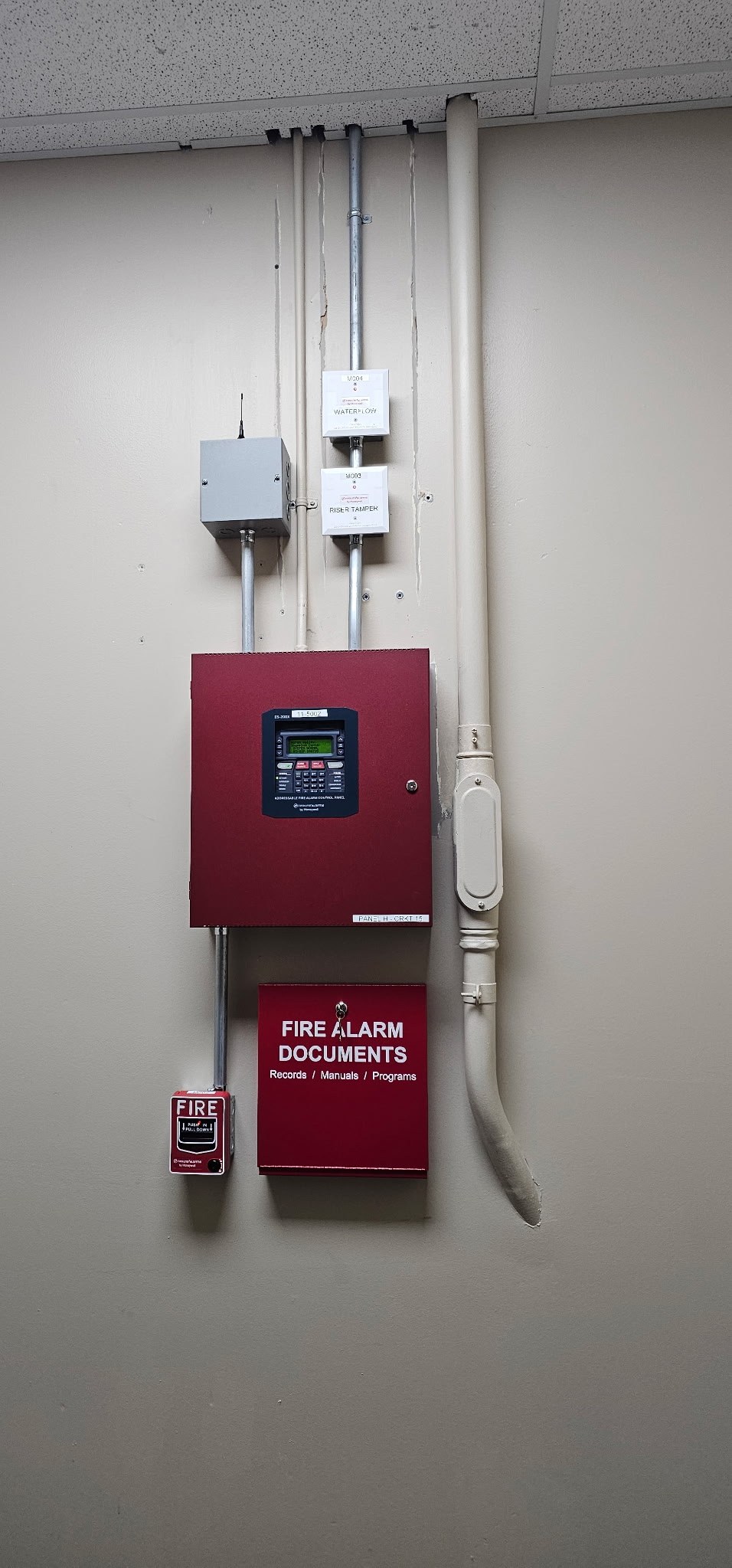 Commercial fire alarm control panel, cellular communicator, pull station and documentation cabinet