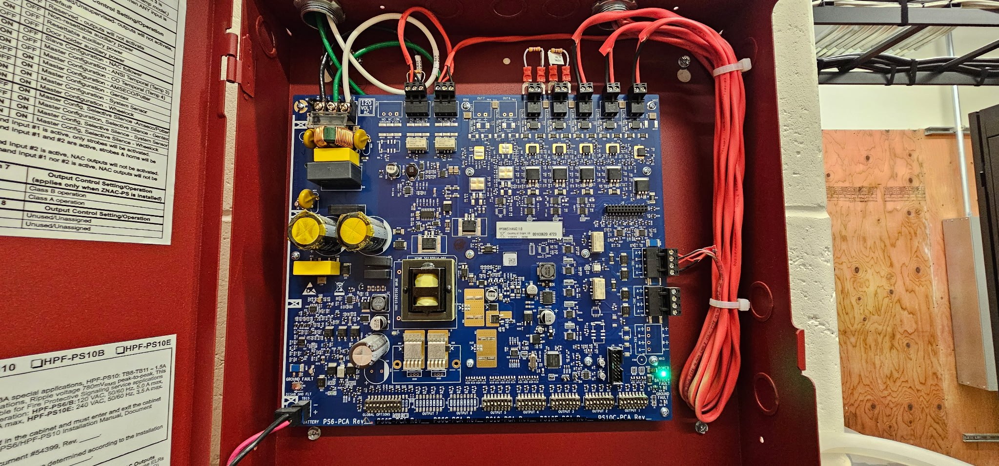 Close-up of commercial fire alarm power supply circuit board and neatly routed wiring